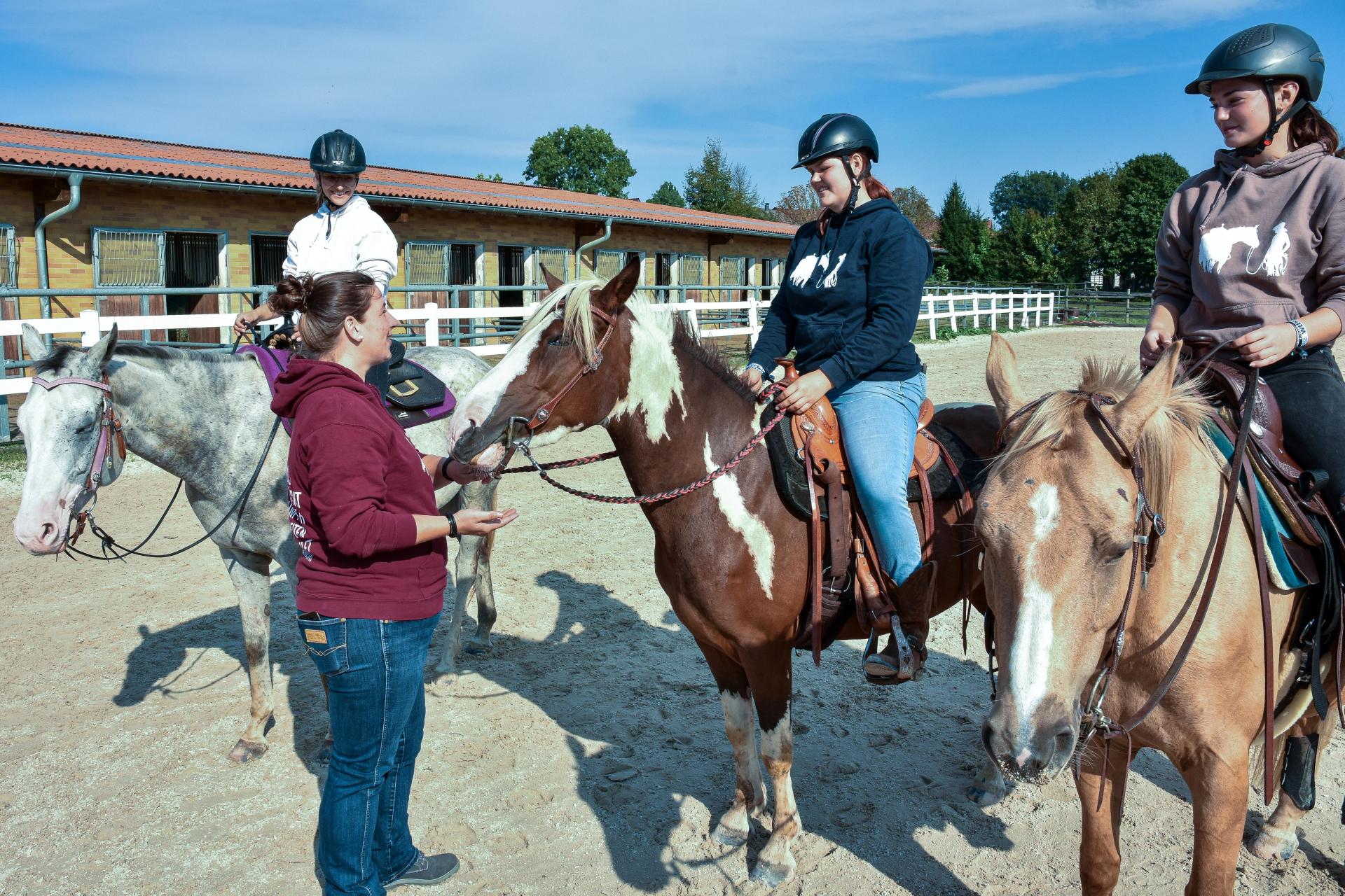 Von Frauenricht zog die Reitschule „Katschmandu Westernriding” auf den Pferdehof Thansüß. Katharina Schmitz (stehend) im Gespräch mit ihren Assistentinnen. (Bild: Stephan Huber)